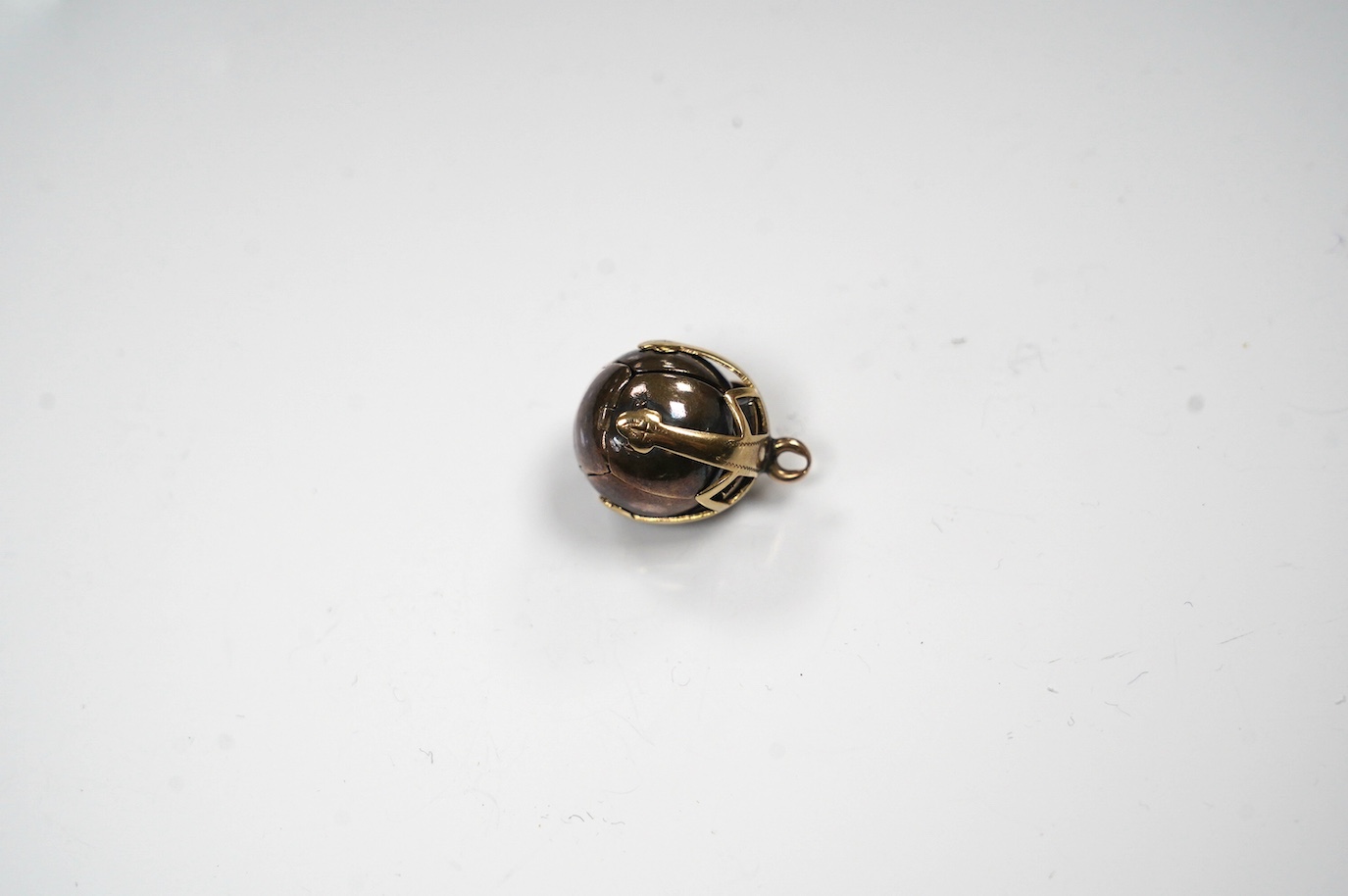 A yellow metal and white metal masonic ball pendant, the yellow metal stamped 9ct, 17mm. Condition - fair